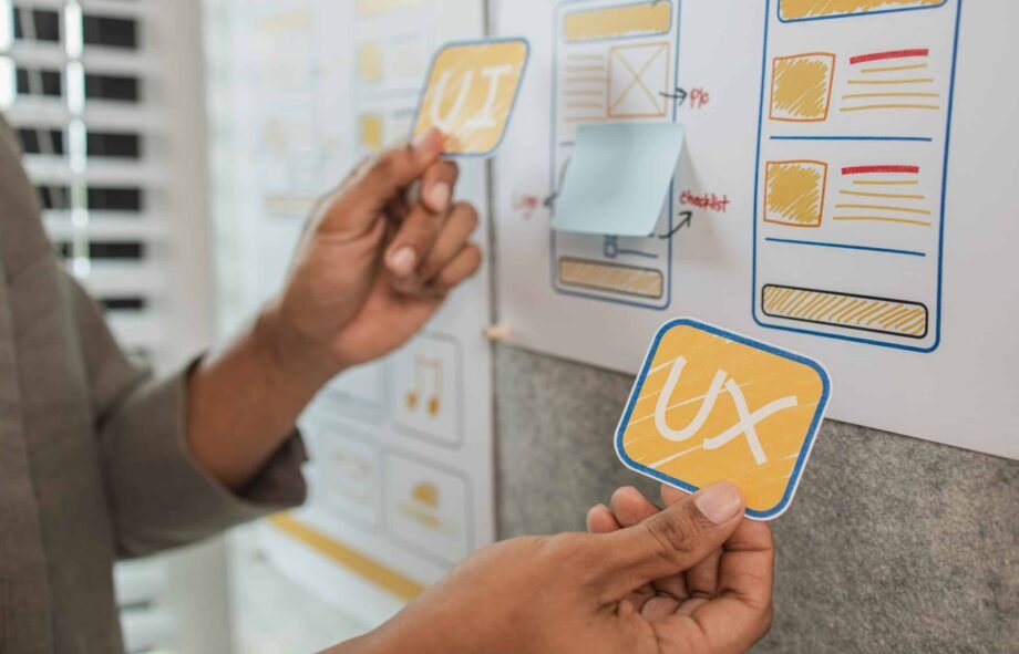 UI UX designers team working on new website wireframe in office, ux developer and ui designer use augmented reality brainstorming about mobile app interface wireframe design on desk at modern office