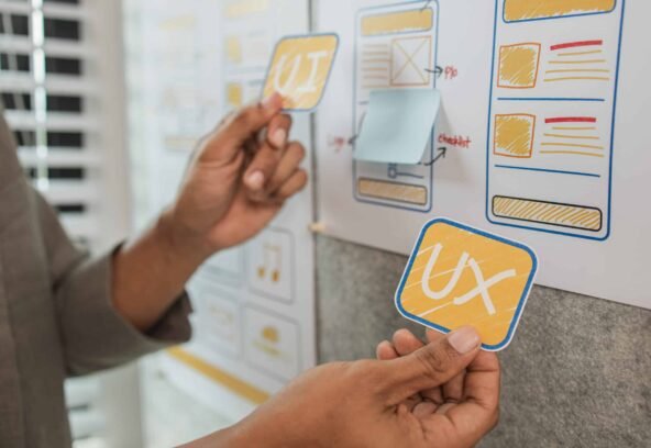 UI UX designers team working on new website wireframe in office, ux developer and ui designer use augmented reality brainstorming about mobile app interface wireframe design on desk at modern office