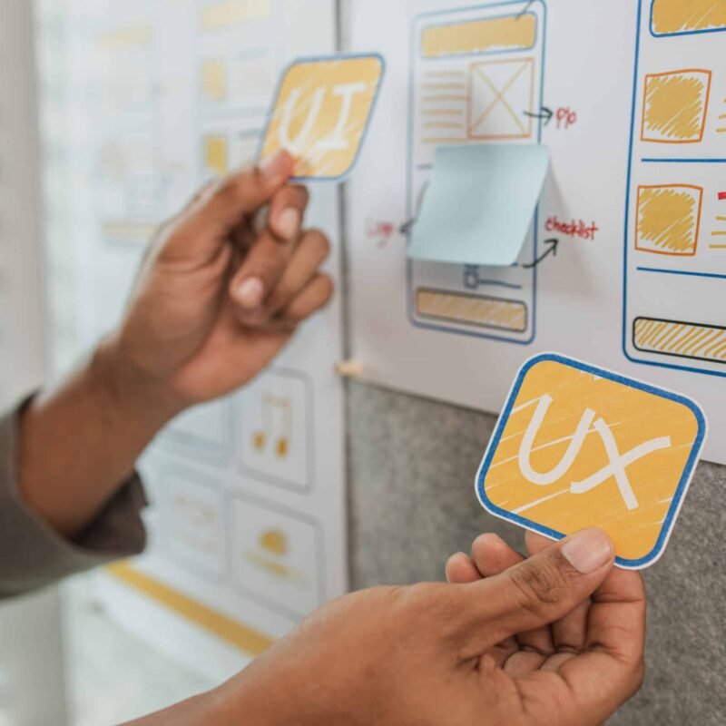 UI UX designers team working on new website wireframe in office, ux developer and ui designer use augmented reality brainstorming about mobile app interface wireframe design on desk at modern office