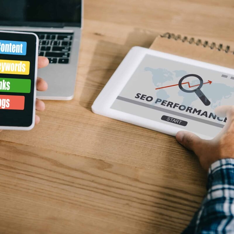 cropped shot of professional developer using different gadgets with SEO performance
