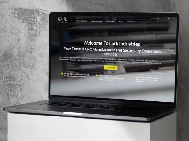 Dallas digital marketing agency example: the Lark Industries website built by Bedrock Digital, shown on a laptop